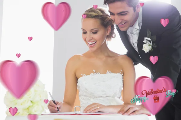 Happy young couple signing wedding register — Stock Photo, Image