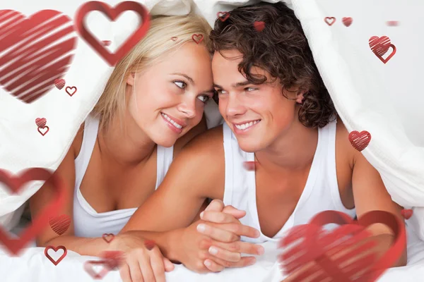 Portrait of an in love couple under a duvet — Stock Photo, Image