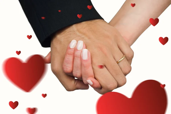 Composite image of newlyweds holding hands close up — Stock Photo, Image