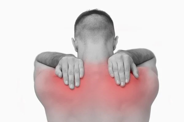 Rear view of shirtless man with shoulder pain — Stock Photo, Image