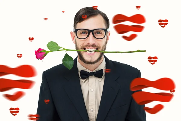 Geeky hipster holding rose between teeth — Stock Photo, Image