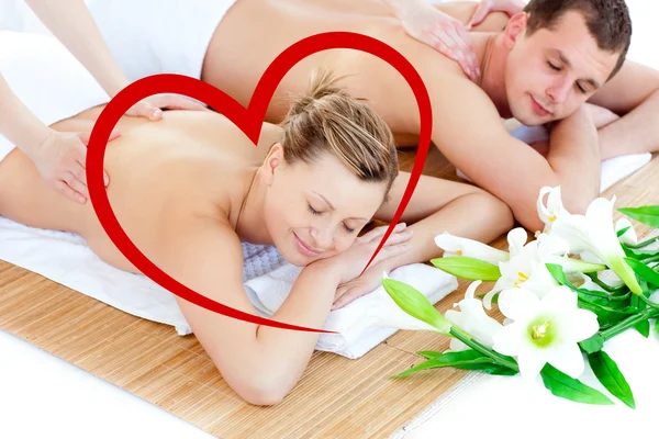 Loving young couple enjoying a back massage — Stock Photo, Image