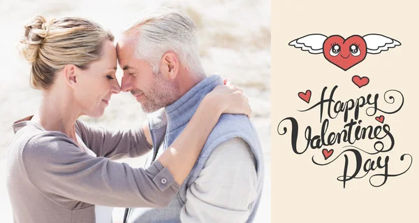 Happy hugging couple on the beach looking — Stock Photo, Image