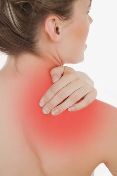 Young woman massaging back — Stock Photo, Image