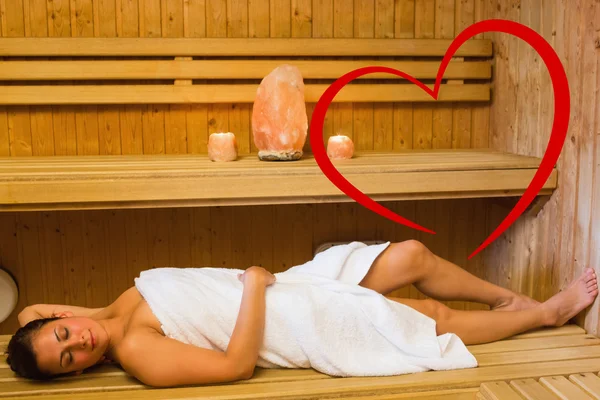 Happy brunette woman lying in a sauna — Stock Photo, Image