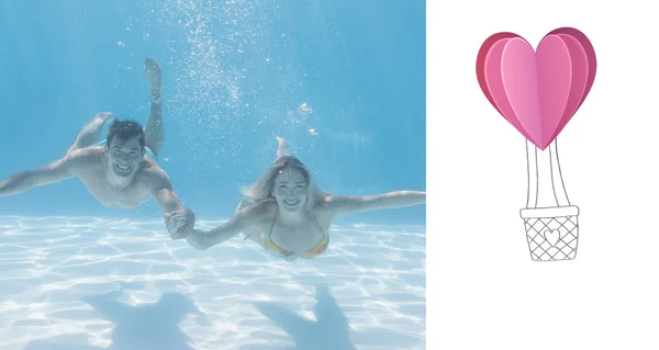 Cute couple smiling at camera underwater — Stock Photo, Image