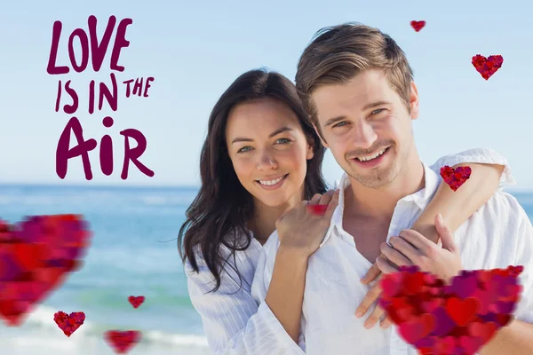 Cheerful couple embracing on the beach — Stock Photo, Image