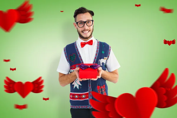 Geeky hipster offering christmas gift — Stock Photo, Image