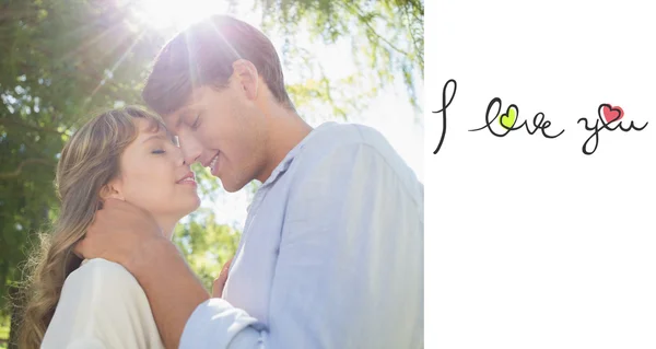 Cute couple hugging and smiling in the park — Stock Photo, Image