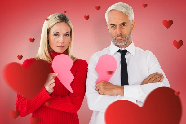 Couple not talking holding two halves of broken heart — Stock Photo, Image