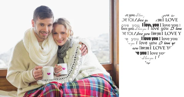 Couple in winter wear with cups — Stock Photo, Image