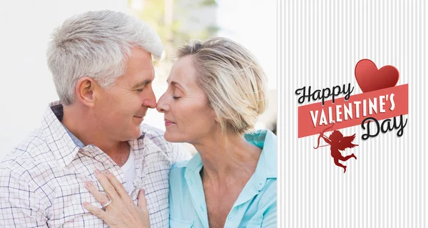 Happy mature couple sitting on bench — Stock Photo, Image