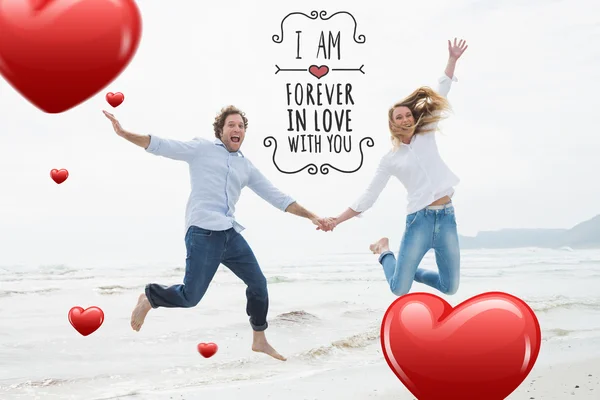 Cheerful couple holding hands and jumping — Stock Photo, Image