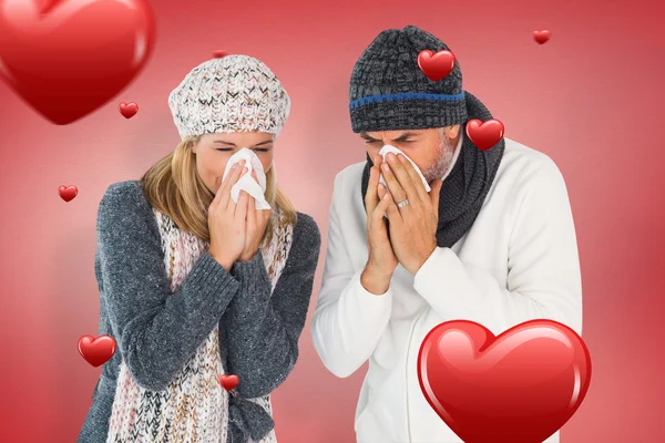 Sick couple in winter fashion sneezing — Stock Photo, Image