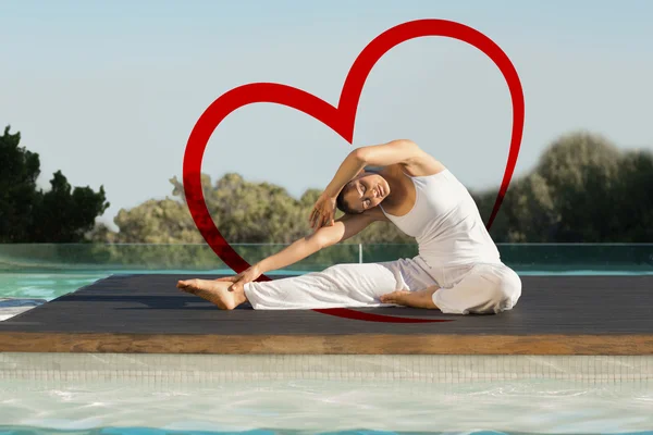 Brunette in janu sirsasana yoga pose — Stock Photo, Image