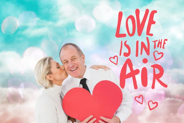Affectionate couple holding red heart — Stock Photo, Image