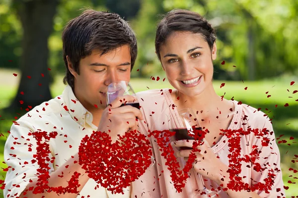 Frau lächelt, während ihr Freund Wein trinkt — Stockfoto