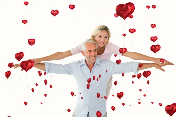 Smiling couple posing with arms out — Stock Photo, Image