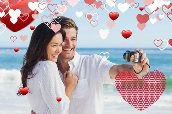 Composite image of happy couple taking a photo — Stock Photo, Image