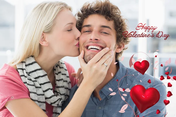 Woman kissing man on his cheek — Stock Photo, Image