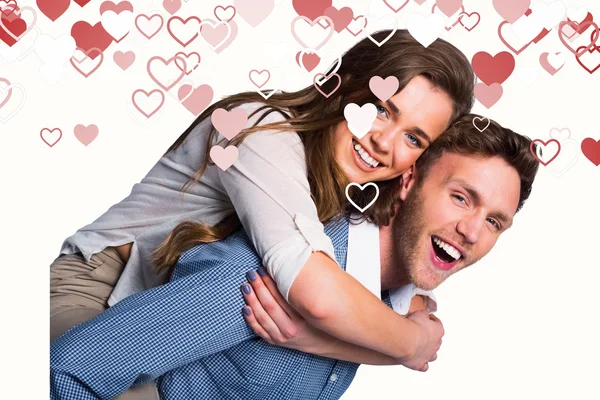 Smiling young man carrying woman — Stock Photo, Image