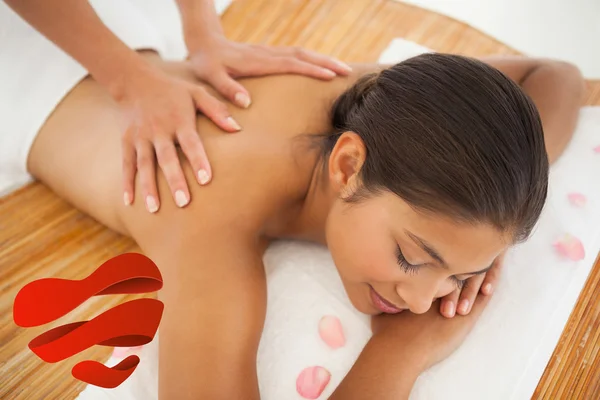 Beautiful brunette enjoying a back massage — Stock Photo, Image