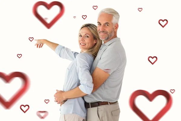 Pareja feliz sonriendo a la cámara y señalando — Foto de Stock