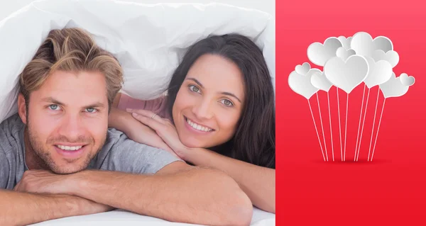 Beautiful couple smiling under the cover — Stock Photo, Image