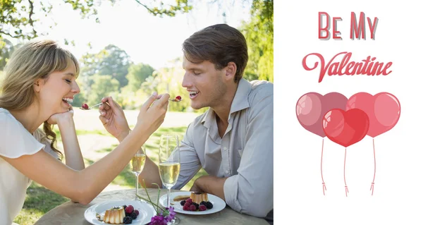 Cute couple feeding each other dessert — Stock Photo, Image