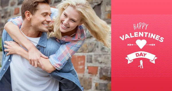 Man giving his pretty girlfriend a piggy back — Stock Photo, Image