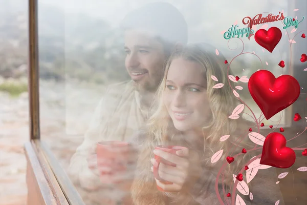 Thoughtful content couple with cups — Stock Photo, Image