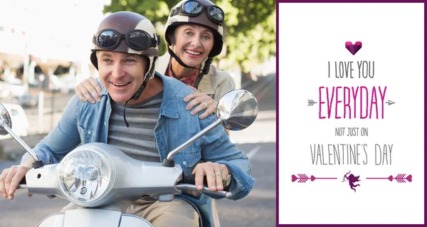 Happy mature couple riding a scooter — Stock Photo, Image