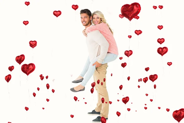 Man giving piggy back to girlfriend — Stock Photo, Image