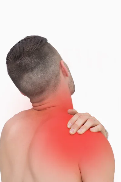 Rear view of shirtless man with shoulder pain — Stock Photo, Image