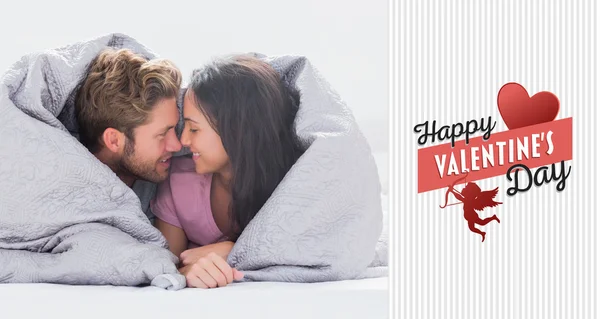 Couple wrapped in the duvet — Stock Photo, Image