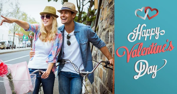 Hip young couple standing by brick wall — Stock Photo, Image