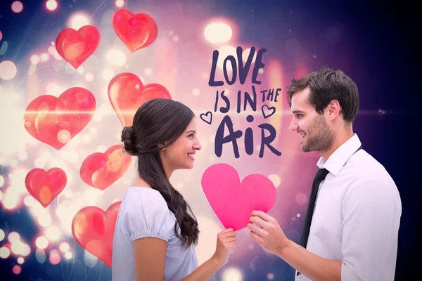 Pretty brunette giving boyfriend her heart — Stock Photo, Image