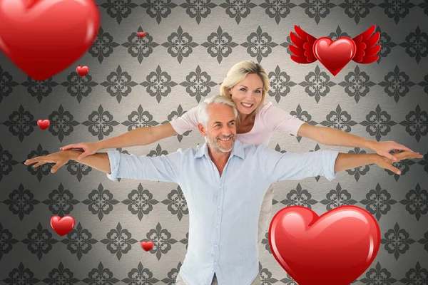 Smiling couple posing with arms out — Stock Photo, Image