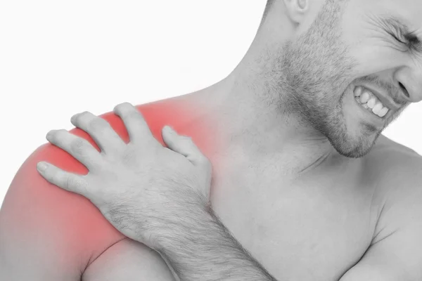 Young shirtless man with shoulder pain — Stock Photo, Image