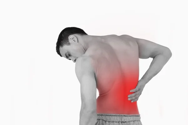 Обратный вид человека, страдающего от болей в спине — стоковое фото