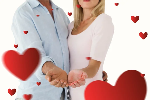 Happy couple holding their hands out — Stock Photo, Image