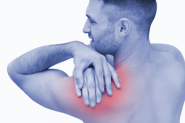 Rear view of shirtless man with shoulder pain — Stock Photo, Image