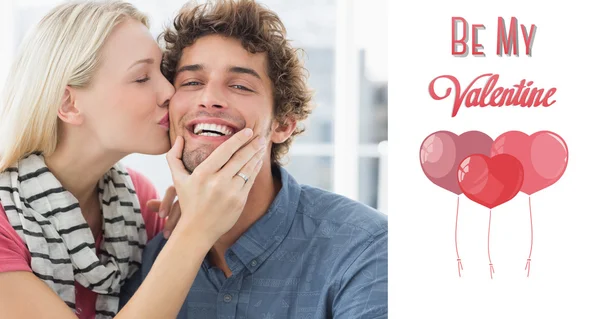 Woman kissing man on his cheek — Stock Photo, Image