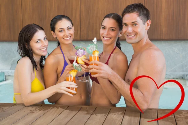 Cheerful people toasting drinks in the swimmig — Stock Photo, Image