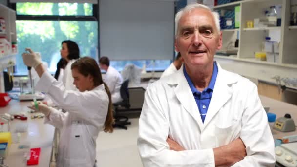 Science professor smiling at camera in class — Stock Video