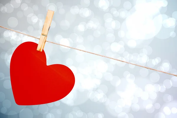 Composite image of heart hanging on line — Stock Photo, Image