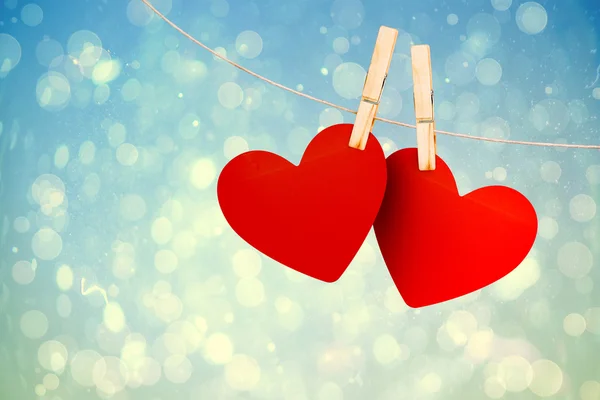Composite image of hearts hanging on line — Stock Photo, Image