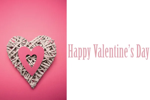 Composite image of wicker heart ornament with pink paper cut out — Stock Photo, Image