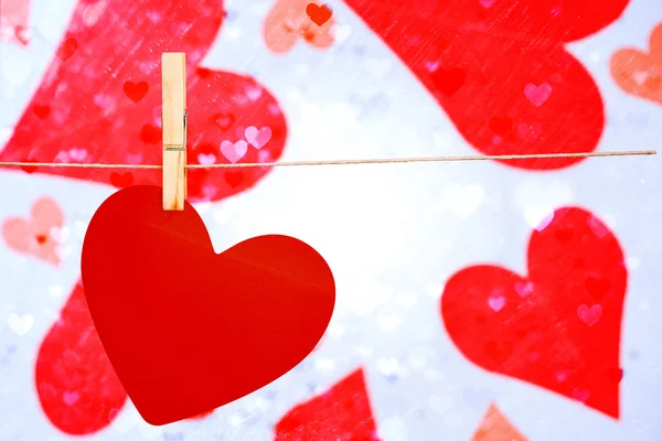 Composite image of heart hanging on line — Stock Photo, Image