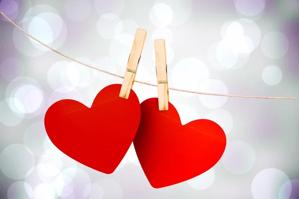 Composite image of hearts hanging on line — Stock Photo, Image